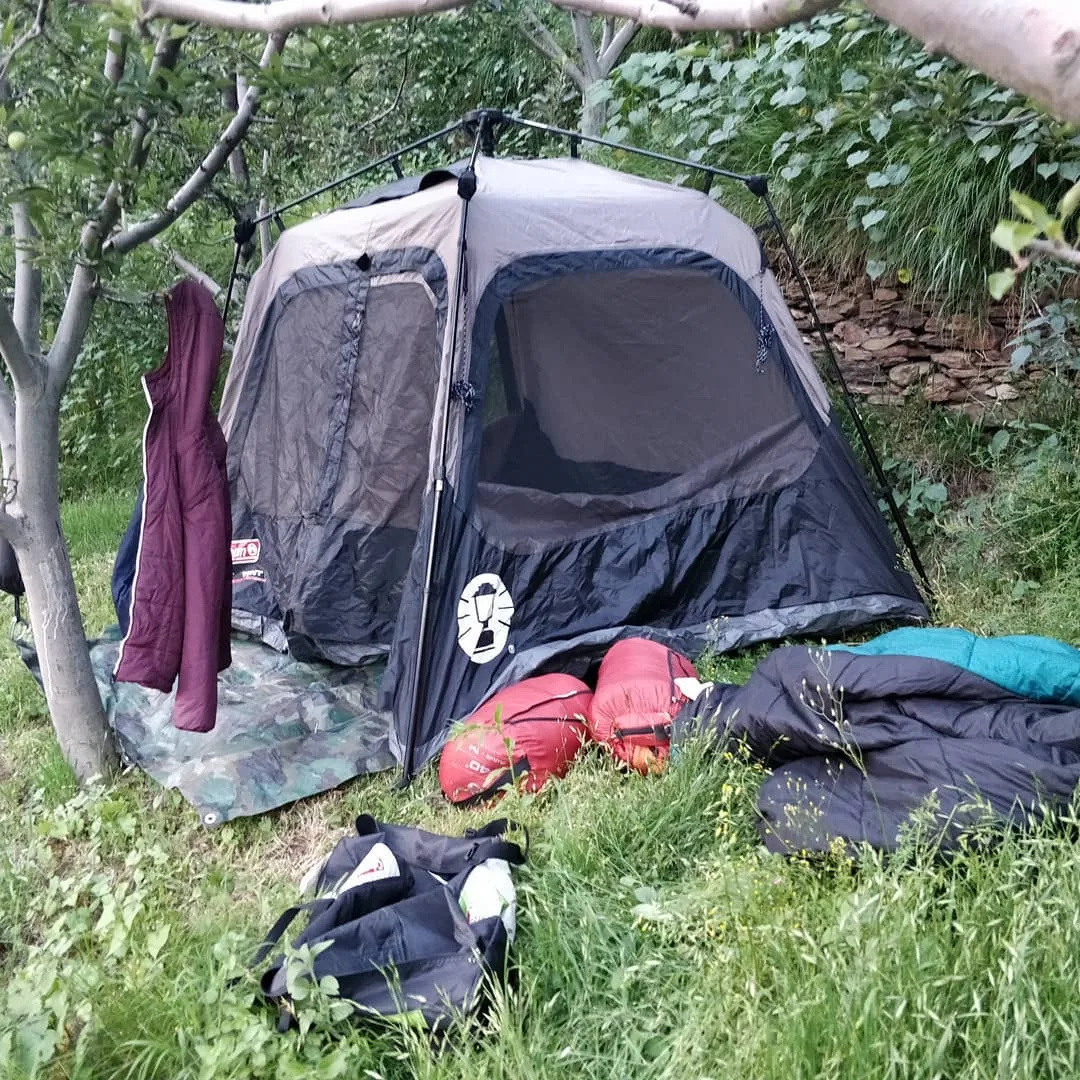 The #tarp is laid out. The instant #tent is popped up. The foam #mattresses have been laid out in the tent. And the sleeping #bags have been thrown in. We move fast inspite of the 