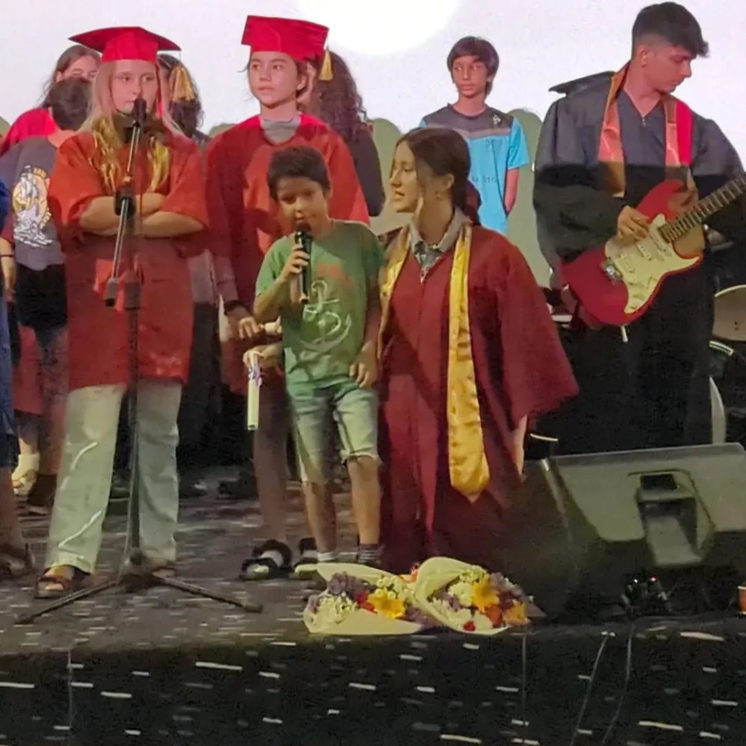 Something about this gesture, of a senior student encouraging a junior through the finale performance of Imagine...