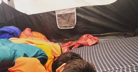 In a hurry last night, we had pitched tent on a slight slope. The upper half is on a slope, the lower half is flat.

Whe
